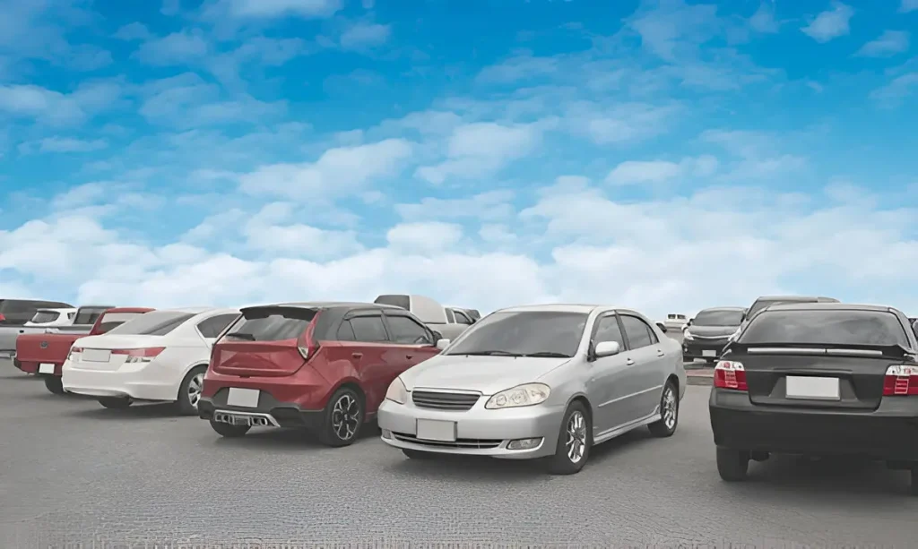 Multiple cars parked under a blue sky, representing vehicles that may qualify for lemon law claims.