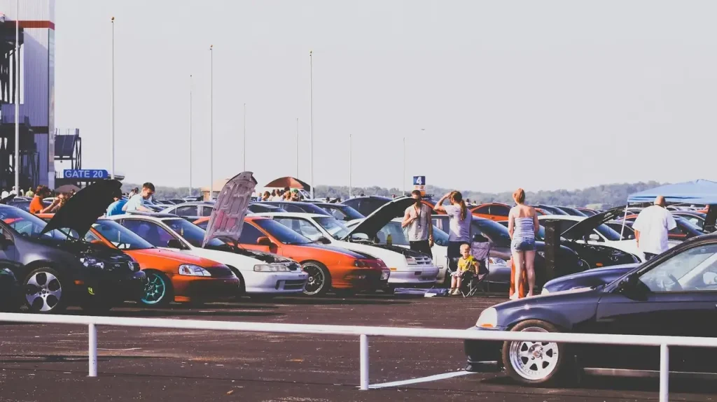parked cars being inspected by people