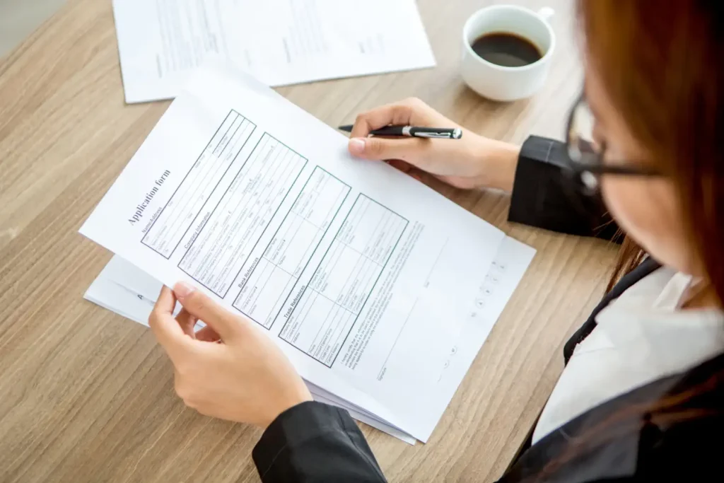 Businesswoman reading application form, lemonlawassist