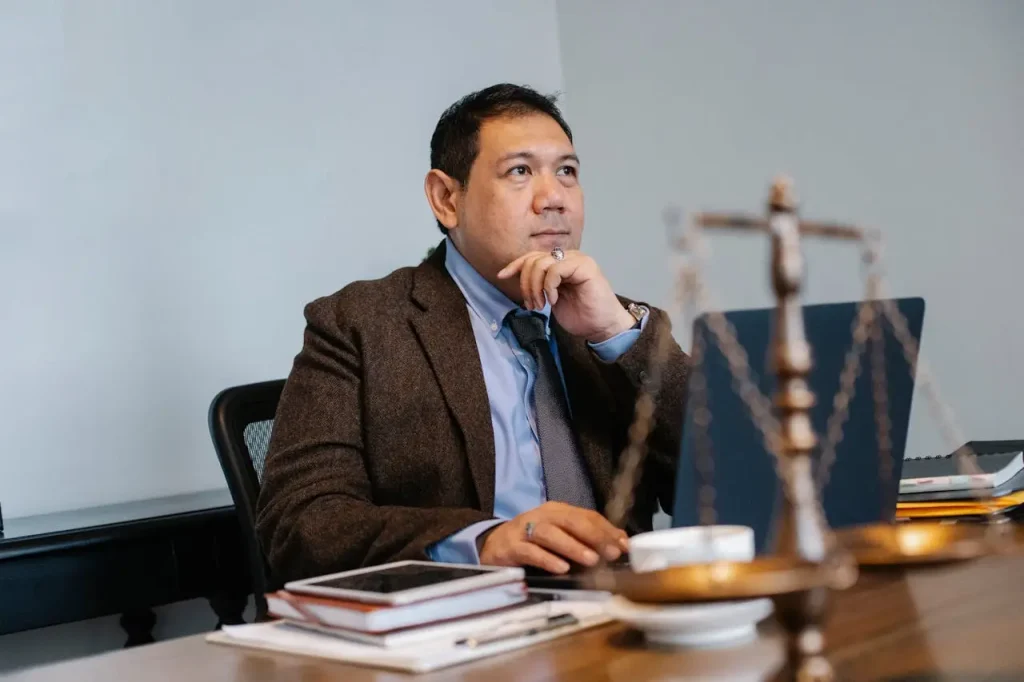 Male attorney working on laptop in office