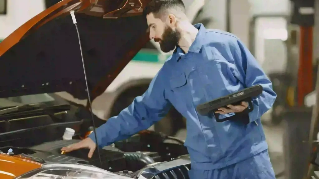 Mechanic checking the engine of a car