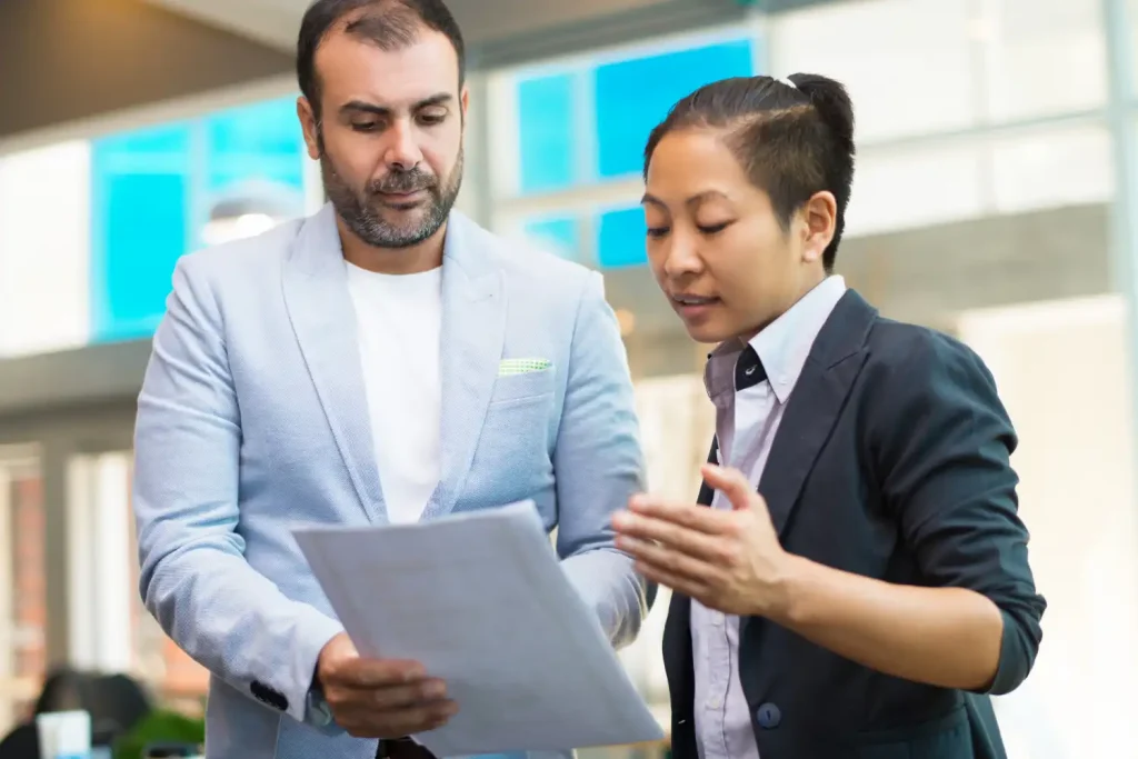 two person discussing document