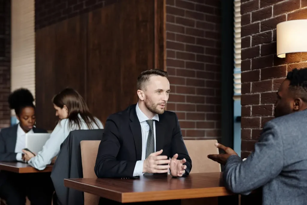 Lawyer talking at a cafe, lemonlawassist