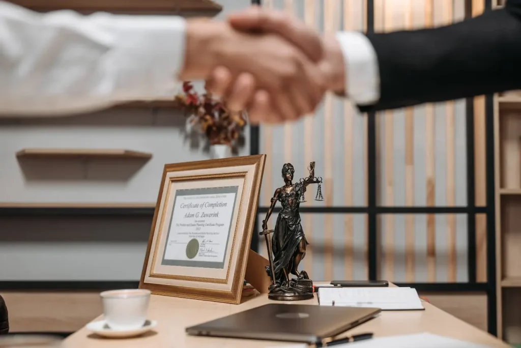 People shaking hands at lawyers office, lemonlawassist