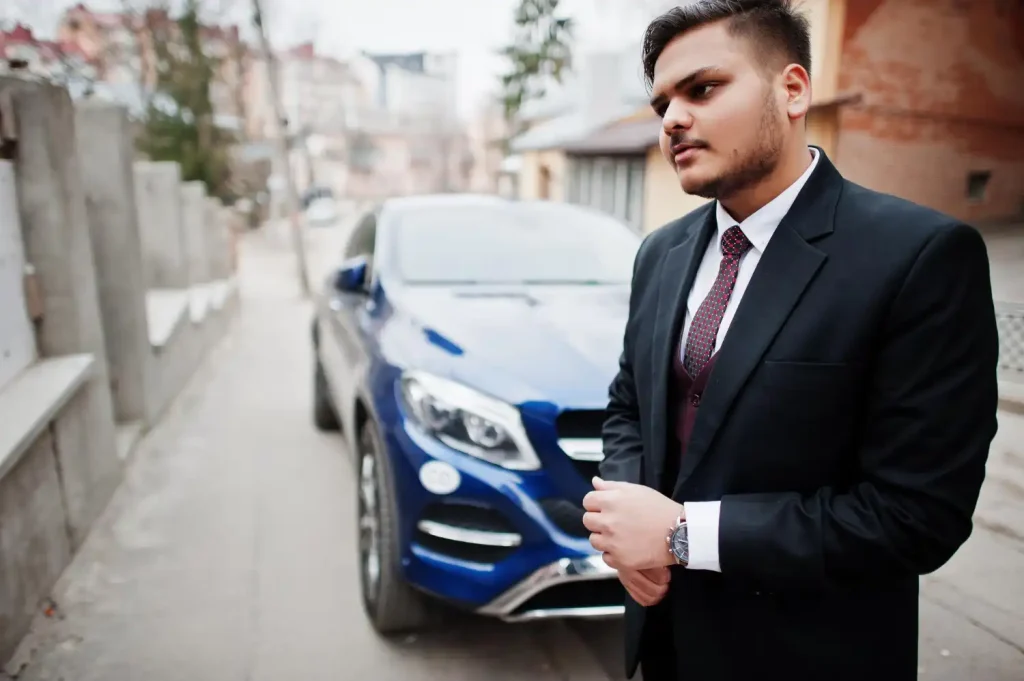 Lawyer in formal wear standing against business suv car, lemonlawassist