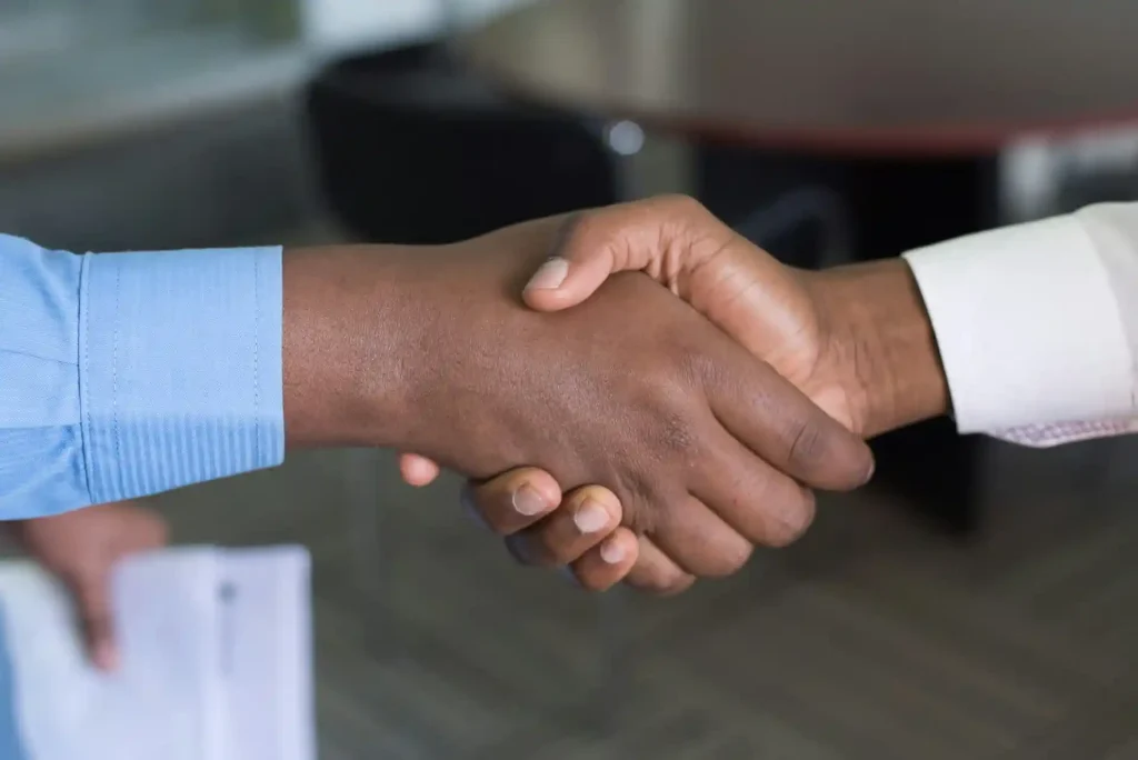 Close-up of two people shaking hands, symbolizing agreement, lemonlawassist