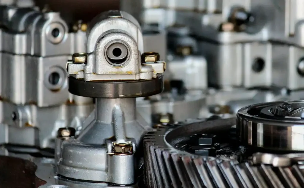 Close-up view of a metal gear mechanism, showcasing industrial engine transmission, lemonlawassist