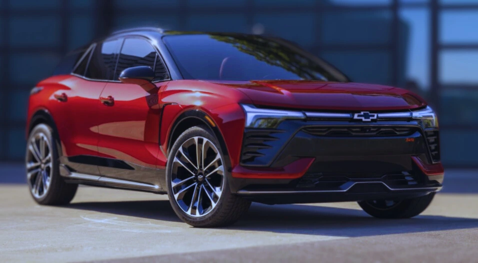 Red Chevrolet electric SUV parked in front of a modern building, showcasing sleek design and futuristic features, lemonlawassist