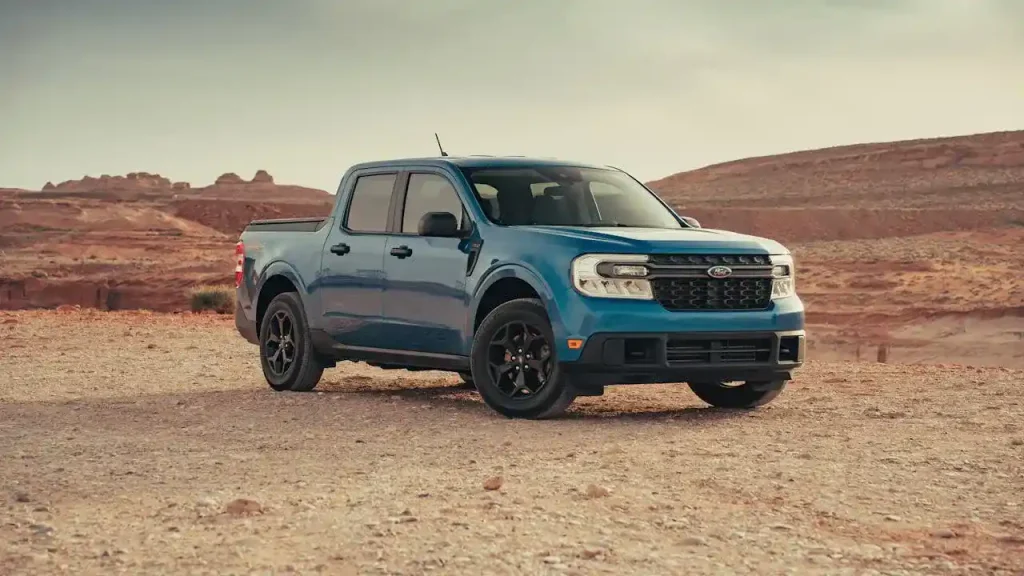 Blue Ford pickup truck parked on a desert landscape, highlighting its rugged design, lemonlawassist