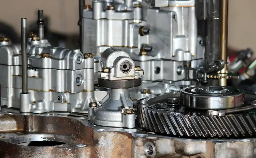 Close-up of a disassembled industrial engine with metal gears and mechanical components, lemonlawassist