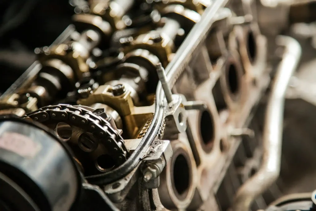 Close-up view of a car engine's internal components, showcasing intricate mechanical details, gears, and timing chain during maintenance, lemonlawassist