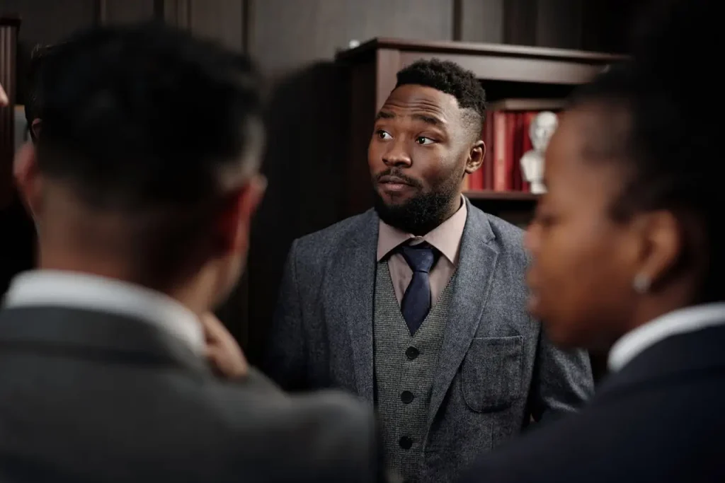 Professional lawyers discussion among formally dressed individuals in an office setting, lemonlawassist