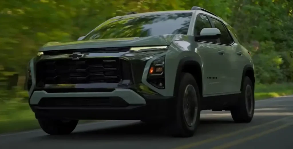 Chevrolet SUV driving on a tree-lined road in daylight, lemonlawassist