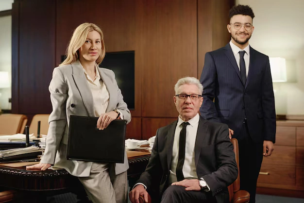 Group of experienced attorneys posing in a professional conference room, dressed in business attire, ready to provide legal expertise, lemon law assist