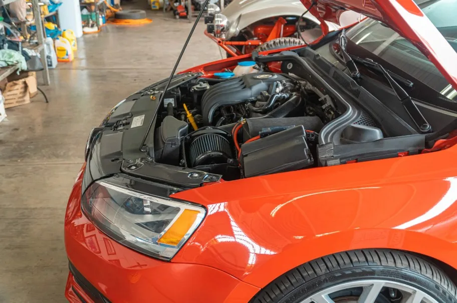 Car engine maintenance with mechanic working under the hood of a vehicle, lemonlawassist