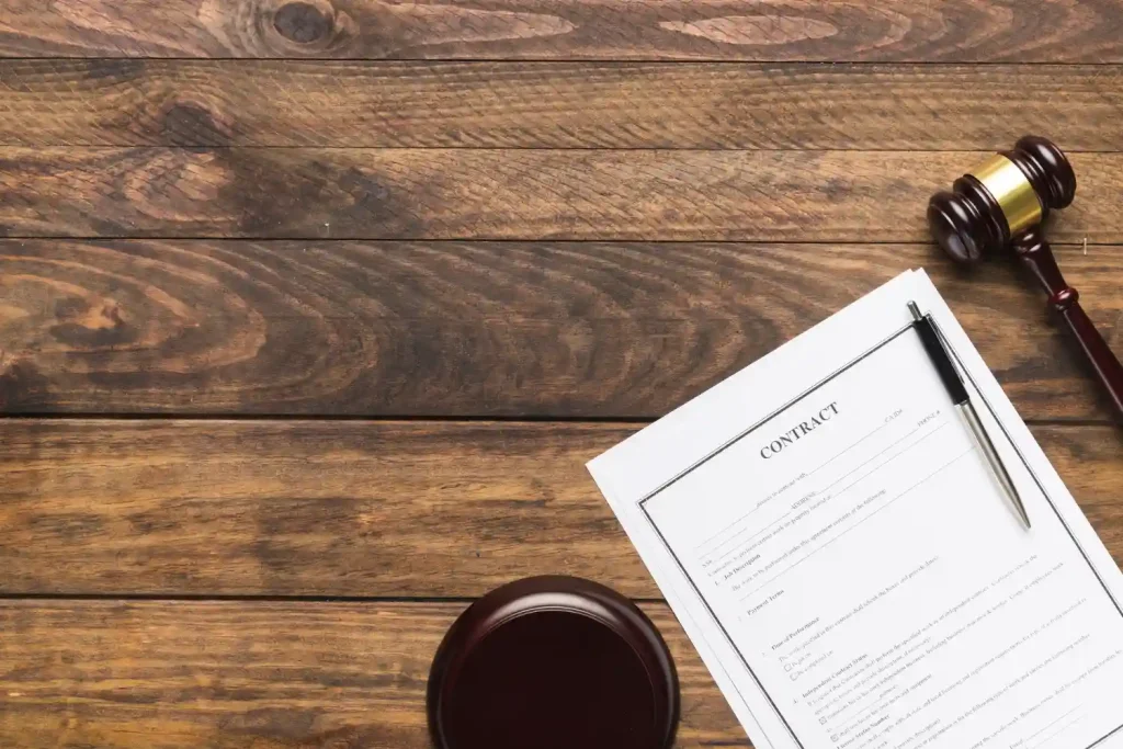 Legal contract with gavel and pen on wooden desk, lemonlawassist