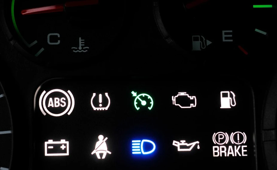 Car dashboard warning lights indicate possible defects, highlighting lemon law issues handled by Lemon Law Assist.