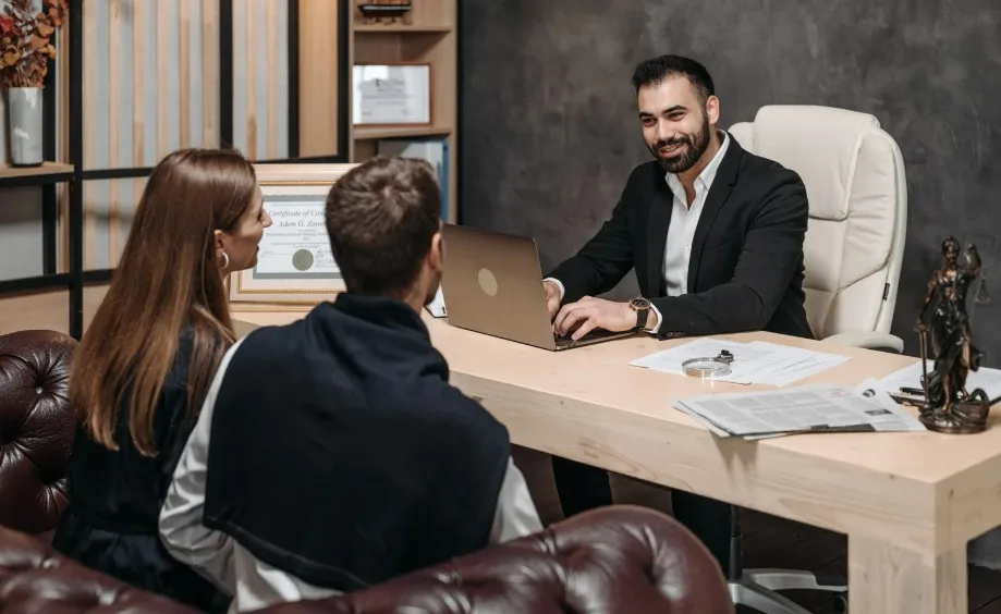 Couple meeting with a lemon law attorney for legal advice on defective vehicle claims at Lemon Law Assist