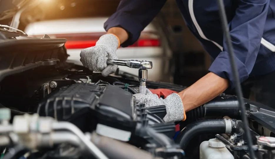 Mechanic diagnosing an engine to identify possible defects covered by lemon law protections, lemonlawassist